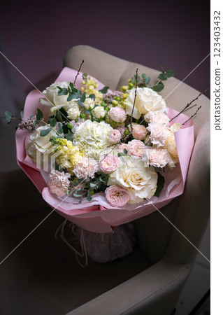 A Stunning Arrangement Featuring a Beautiful Bouquet of Pink and White Roses Alongside Lilies 123403432