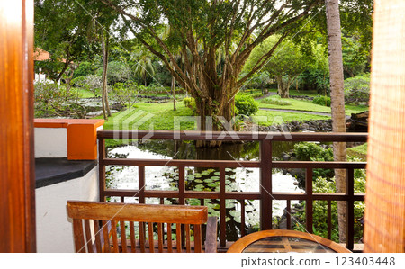 Cozy wooden house balcony with with tropical tree, Bali, Indonesia 123403448