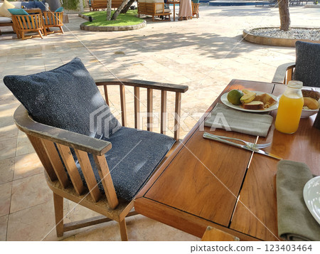 Breakfast table at Asian resort. Pancakes, sandwiches, coffee, juices, salad, fresh fruits. Healthy, delicious dishes on a sunny Bali vacation. 123403464