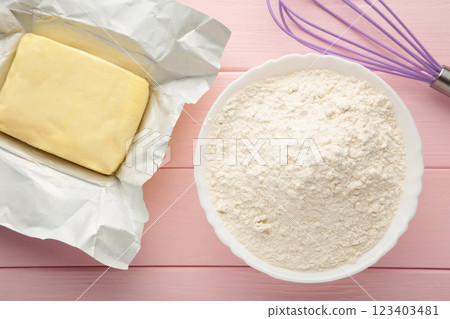 Ingredients for baking or cooking, egg flour, rolling pin butter, milk on a pink wooden background Cookie pie or cake recipe. Ingredients for baking or cooking, egg flour, rolling pin butter, milk on a pink wooden background Cookie pie or cake recipe. 123403481
