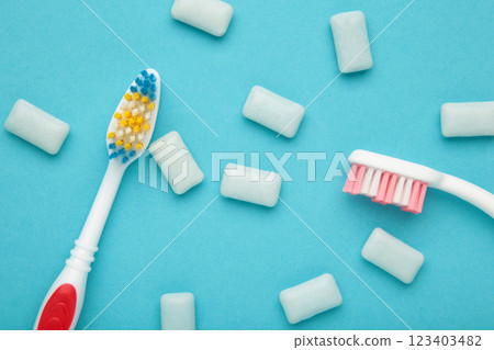 Toothbrush and chewing gums on a pastel blue background. Minimal concept Toothbrush and chewing gums on a pastel blue background. Minimal concept 123403482