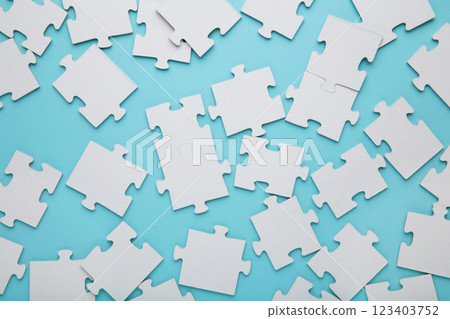 Close-up of a pile of uncompleted elements of a white puzzle. A huge number of rectangular pieces from one large white mosaic Close-up of a pile of uncompleted elements of a white puzzle. A huge number of rectangular pieces from one large white mosaic 123403752