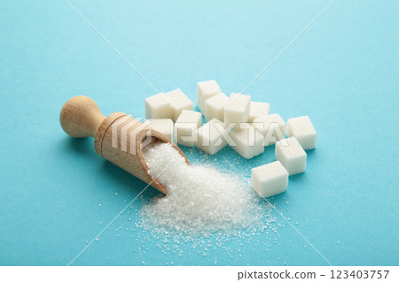 White sugar in wood spoon on blue background. 123403757