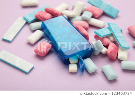Different chewing gums on purple background. 123403784