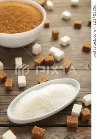 White and brown sugar in bowl on grey background. Vertical photo White and brown sugar in bowl on grey background. Vertical photo 123403856