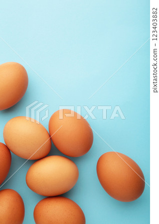 Chicken eggs on yellow background. Farm products, natural eggs. Vertical photo 123403882