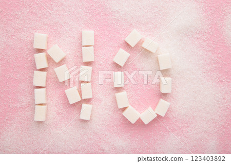 Words no sugar written with sugar on a pink background Words no sugar written with sugar on a pink background 123403892