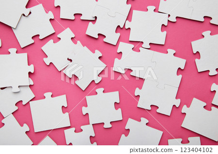 Close-up of a pile of uncompleted elements of a white puzzle. A huge number of rectangular pieces from one large white mosaic 123404102
