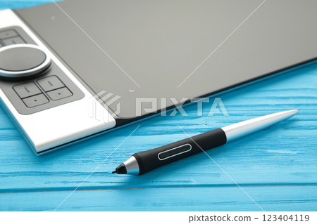 Graphic designer using digital tablet on blue background 123404119