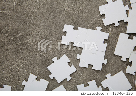 Uncompleted elements of a white puzzle on grey background. Space for text Uncompleted elements of a white puzzle on grey background. Space for text 123404139