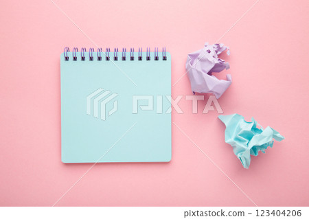 Blank paper notebook and damaged sheets on pink background. Office desk table concept. 123404206