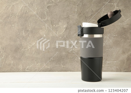 Black thermo mug on the grey background. 123404207