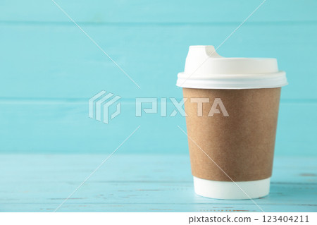 Craft paper cup with space for text on blue background. 123404211