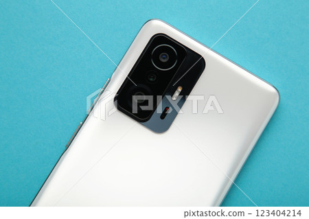 Mobile phone camera, flash lens on blue background. 123404214