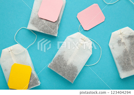 Tea bags with labels on blue background. Minimalism, flat lay, place for text. Tea bags with labels on blue background. Minimalism, flat lay, place for text. 123404294