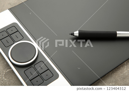Modern graphic tablet on grey background Modern graphic tablet on grey background 123404312