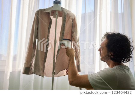 Steam cleaning your garments ensures a crisp, polished finish that enhances their appearance Steam cleaning your garments ensures a crisp, polished finish that enhances their appearance 123404422