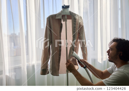 Steam cleaning your garments ensures a crisp, polished finish that enhances their appearance 123404426