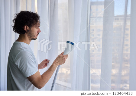 Steam cleaning curtains gives them a vibrant look, enhancing home 123404433