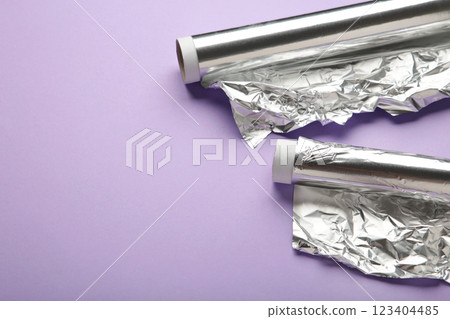 Roll of aluminum foil on purple background. Space for text Roll of aluminum foil on purple background. Space for text 123404485