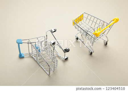 Mini shopping trolleys on a grey background Mini shopping trolleys on a grey background 123404510