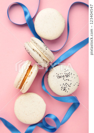 Light cake macaron or macaroon with ribbon on pink background. Sweet background. 123404547