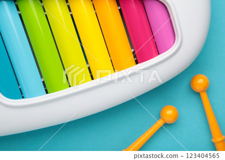 Colorful xylophone on blue background. Space for text 123404565