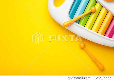 Colorful xylophone on yellow background. Space for text 123404566