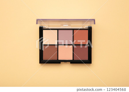 Palette of basic eyeshadows on beige background. Makeup concept 123404568