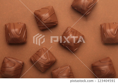 Chocolate candies on brown background. Top view 123404591
