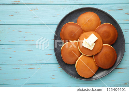 Homemade pancakes with butter in plate on blue background 123404601