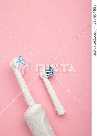 Modern electric toothbrush on pink background. Controlled tool for daily oral care. 123404685