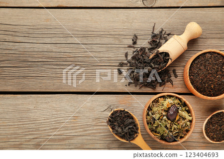 Assortment of dry tea on grey wooden background Assortment of dry tea on grey wooden background 123404693