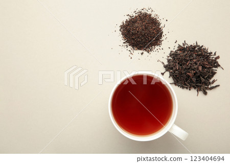 Assortment of dry tea with cup of tea on grey background 123404694
