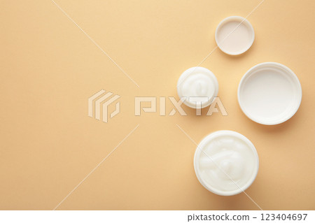 Face cream moisturizer in a jar on beige background. Luxury skincare cosmetics and anti-aging product for healthy skin and beauty routine 123404697
