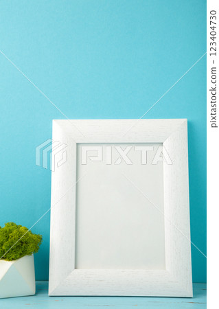 Interior design with white mock up photo frame on blue background with beautiful plants. 123404730