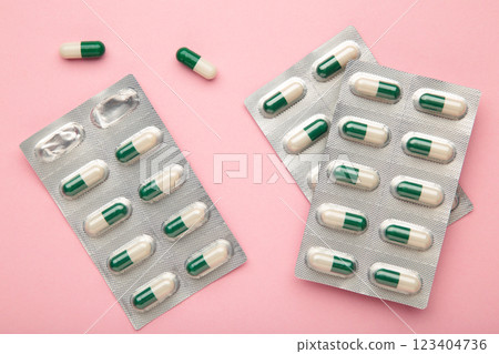 Medical blister packs with pills on pink background. Space for text 123404736