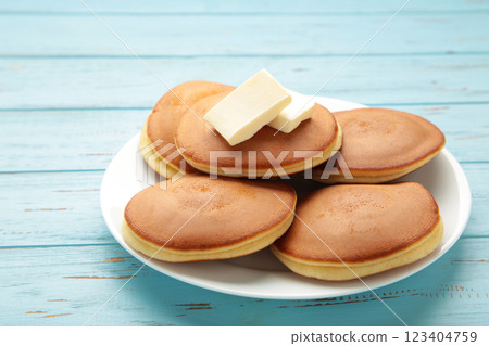 Homemade pancakes with butter in plate on blue background Homemade pancakes with butter in plate on blue background 123404759