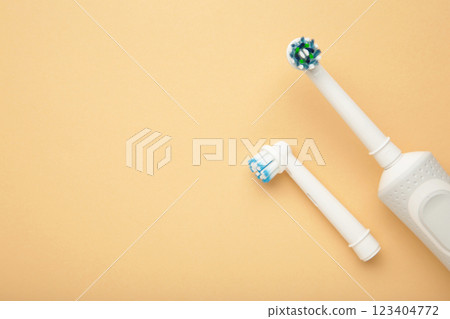 Modern electric toothbrush on beige background. Controlled tool for daily oral care. 123404772