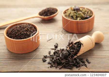 Assortment of dry tea on grey wooden background 123404807