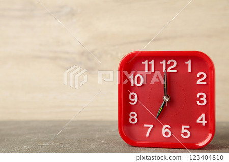 Good morning concept - modern alarm clock and houseplant on light background Good morning concept - modern alarm clock and houseplant on light background 123404810