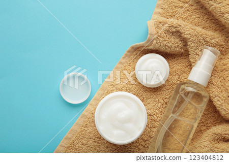 Face cream moisturizer in a jar with towel on blue background. Luxury skincare cosmetics and anti-aging product for healthy skin and beauty routine 123404812