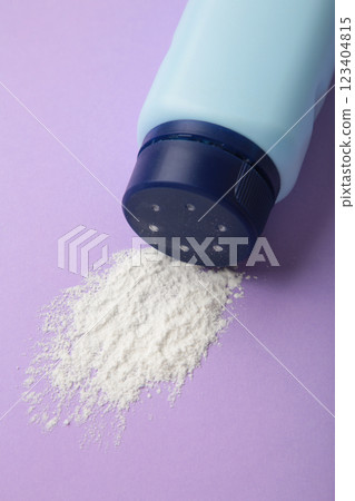 Baby powder on purple background. Baby cosmetics. Vertical photo 123404815