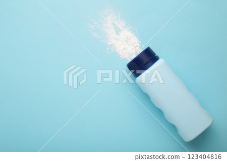 Baby powder on blue background. Baby cosmetics. Space for text Baby powder on blue background. Baby cosmetics. Space for text 123404816