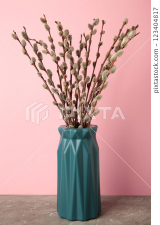 A vase with a willow on pink background. Easter, spring background with copyspace 123404817
