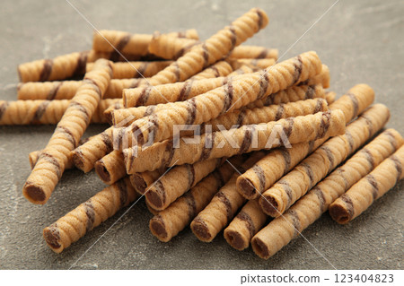 Coffee wafer stick roll with coffee cream on grey background. Coffee wafer stick roll with coffee cream on grey background. 123404823