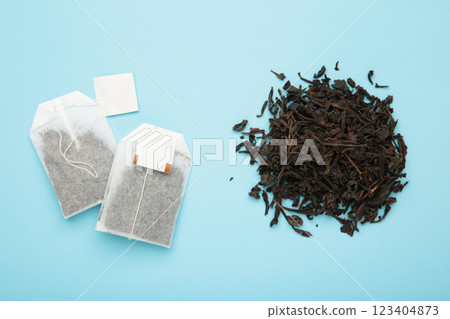 Tea bag and with dry tea leaves on blue background Tea bag and with dry tea leaves on blue background 123404873