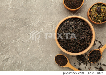 Assortment of dry tea on grey background. Space for text 123404874