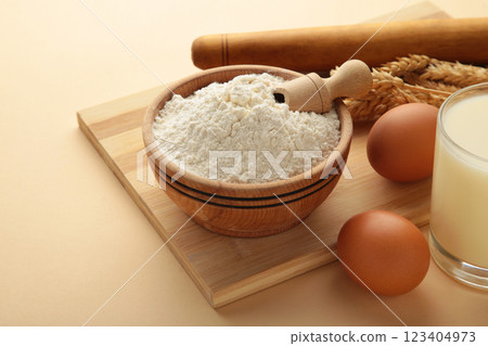 Ingredients for baking or cooking, egg flour, rolling pin butter, milk on a beige background Cookie pie or cake recipe. Ingredients for baking or cooking, egg flour, rolling pin butter, milk on a beige background Cookie pie or cake recipe. 123404973