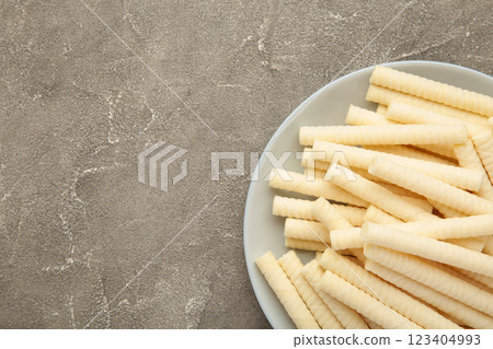 Delicious milk wafer rolls on grey background 123404993